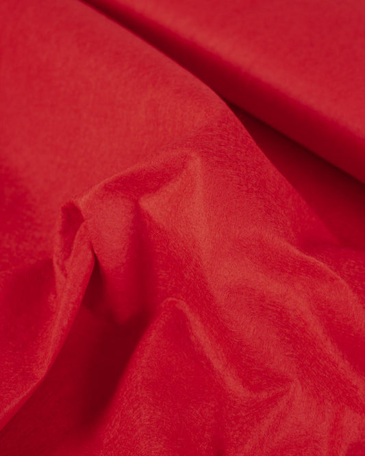 A rushed piece of wool and viscose felt fabric with gentle folds that show its structure and texture.