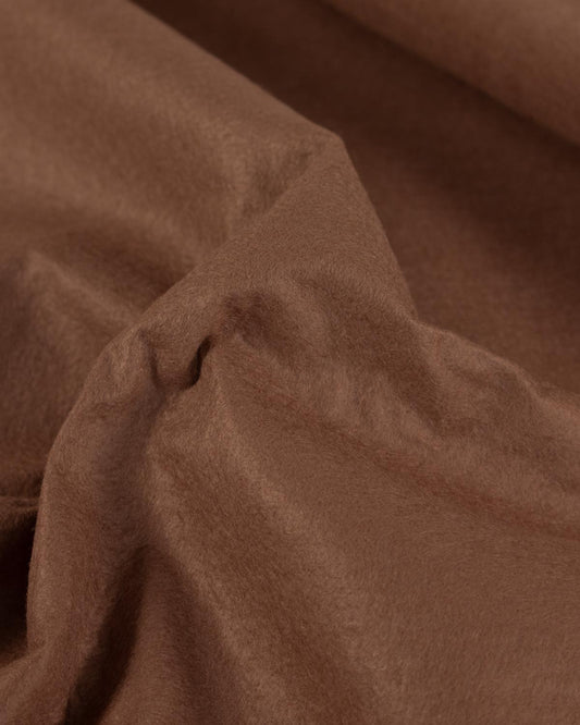 A close-up of draped sable brown wool and viscose felt fabric with soft folds and a smooth, slightly lustrous texture.