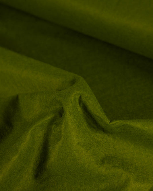 A close-up of moss green wool and viscose felt fabric with soft folds and a slightly textured surface.