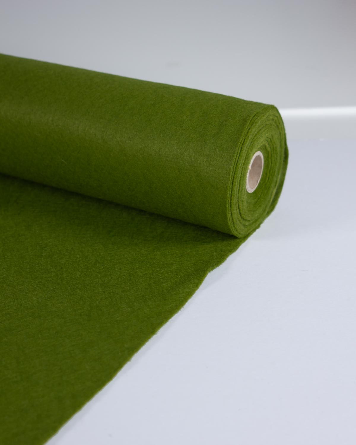 A roll of moss green wool and viscose felt fabric, partially unrolled to show its texture, set against a clean white background.