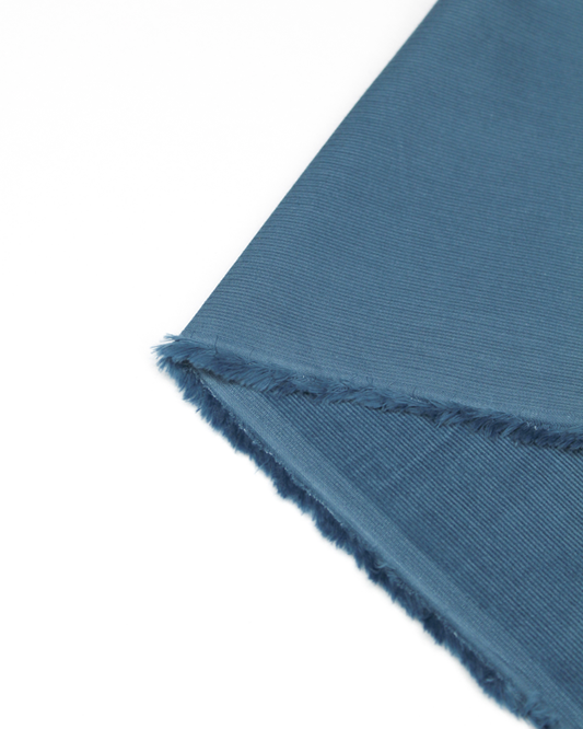 Reverse view of delph blue pure cotton babycord fabric showing fine cord texture