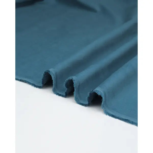 Rippled view of delph blue pure cotton babycord fabric showing fine cord texture