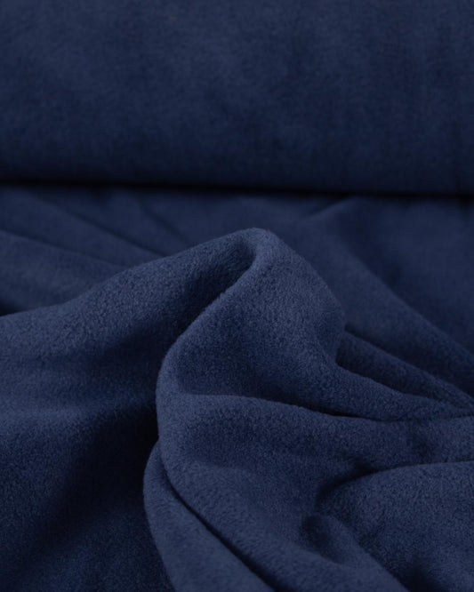 Close up of soft, plush navy blue fleece fabric.