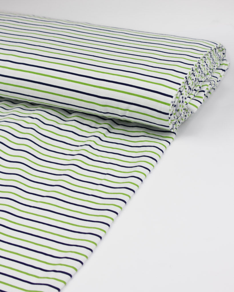 Striped cotton jersey fabric with green and navy lines on a white background