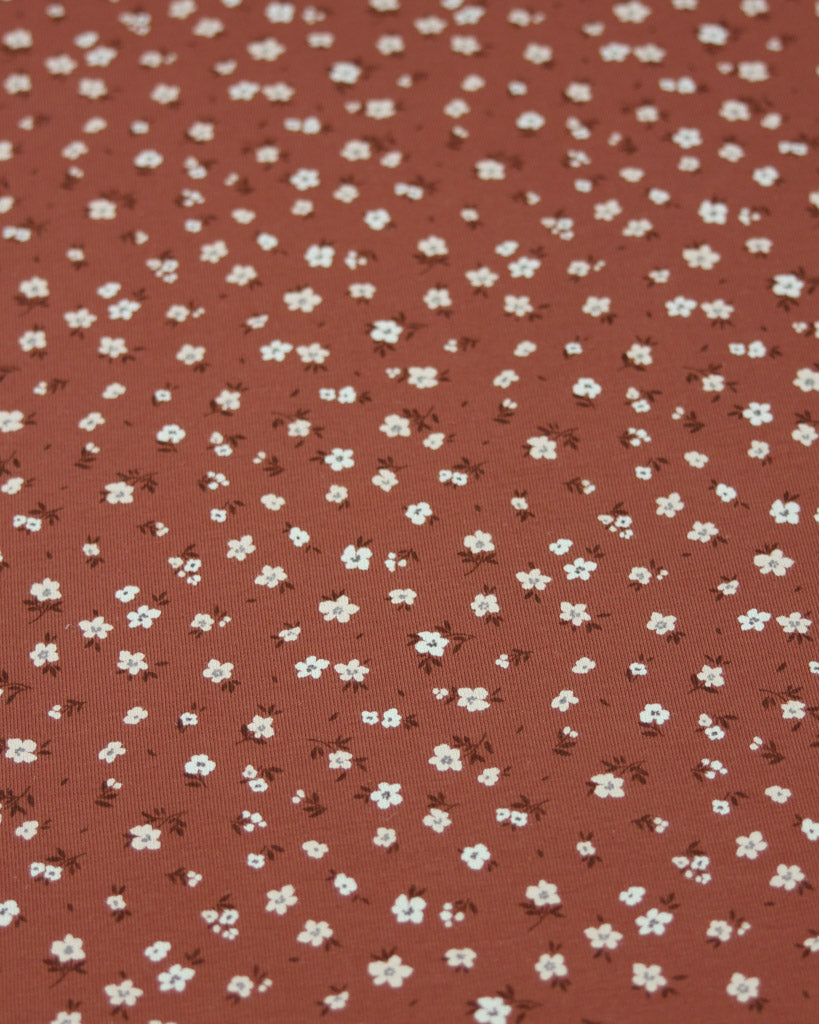 Brown fabric with small white floral pattern