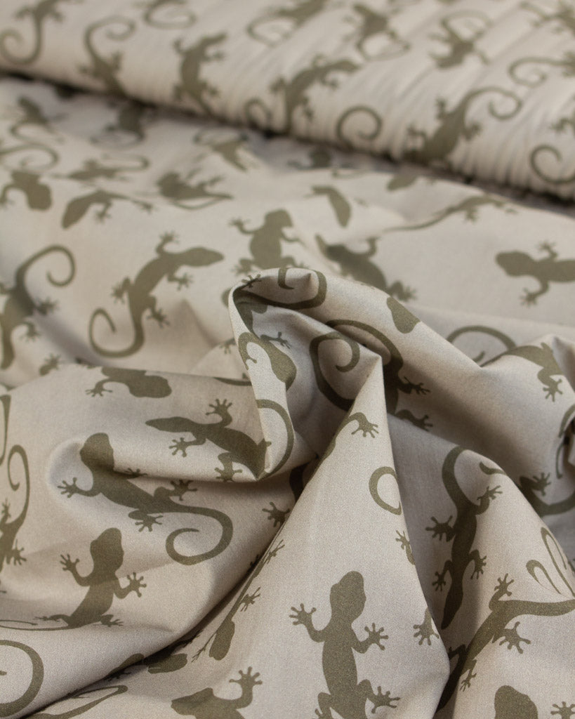 Cotton lawn fabric with lizard pattern on a beige background