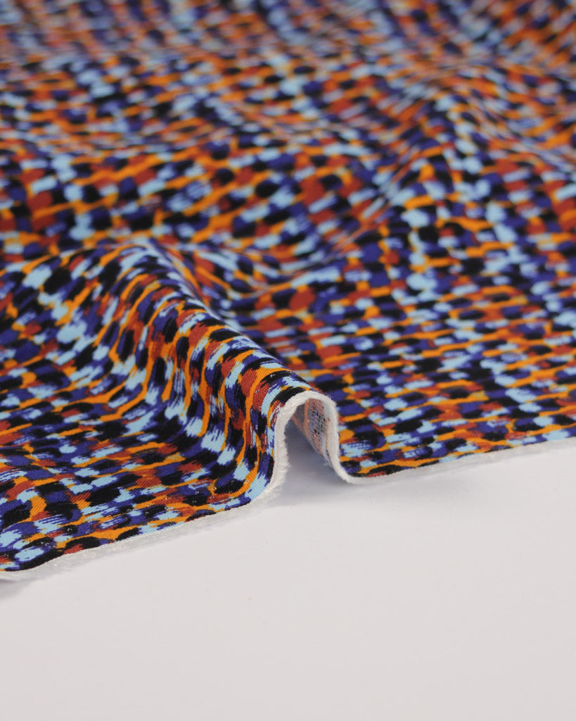 Multicolored viscose twill fabric with a dot pattern on a white background