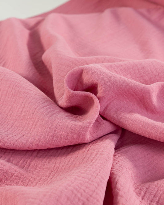 Close-up of Peony pink cotton Double Gauze fabric with a soft texture