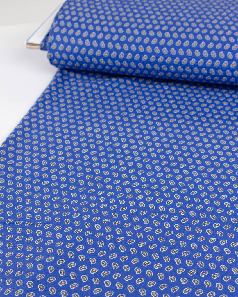 Textured sapphire cotton fabric with tiny blue and yellow paisley motifs