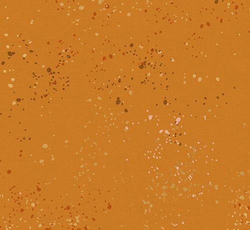 Canvas fabric with speckled metallic pattern on a mustard background