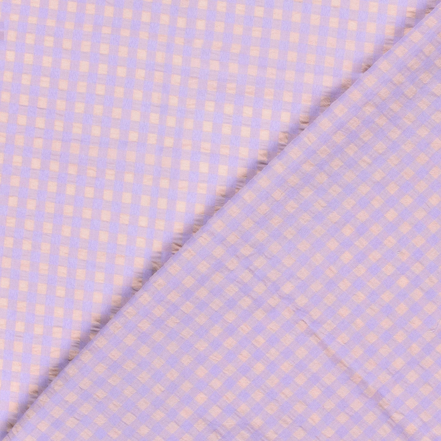 Fabric with a subtle checkered pattern on a light purple background