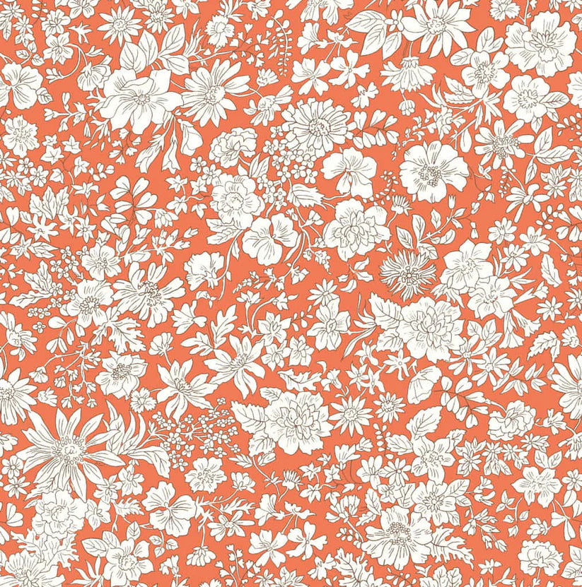 White floral pattern on an orange quilting cotton