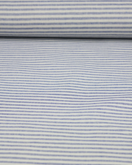 Roll of fabric with blue and white striped pattern