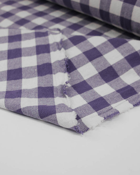 Close-up of purple and white ginghams checkered organic cotton fabric