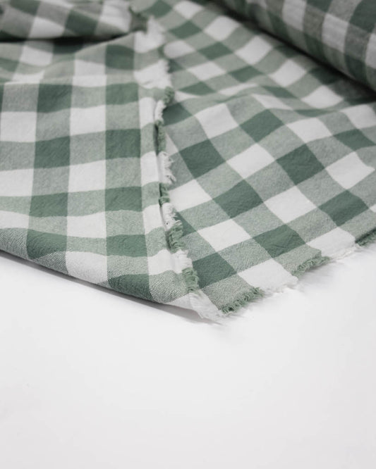 Green and white checkered fabric on a white background