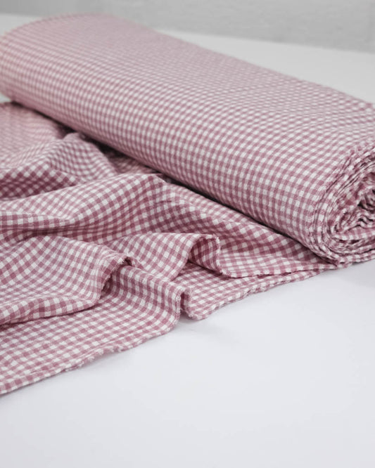 Roll of pink and white checkered gingham organic cotton fabric