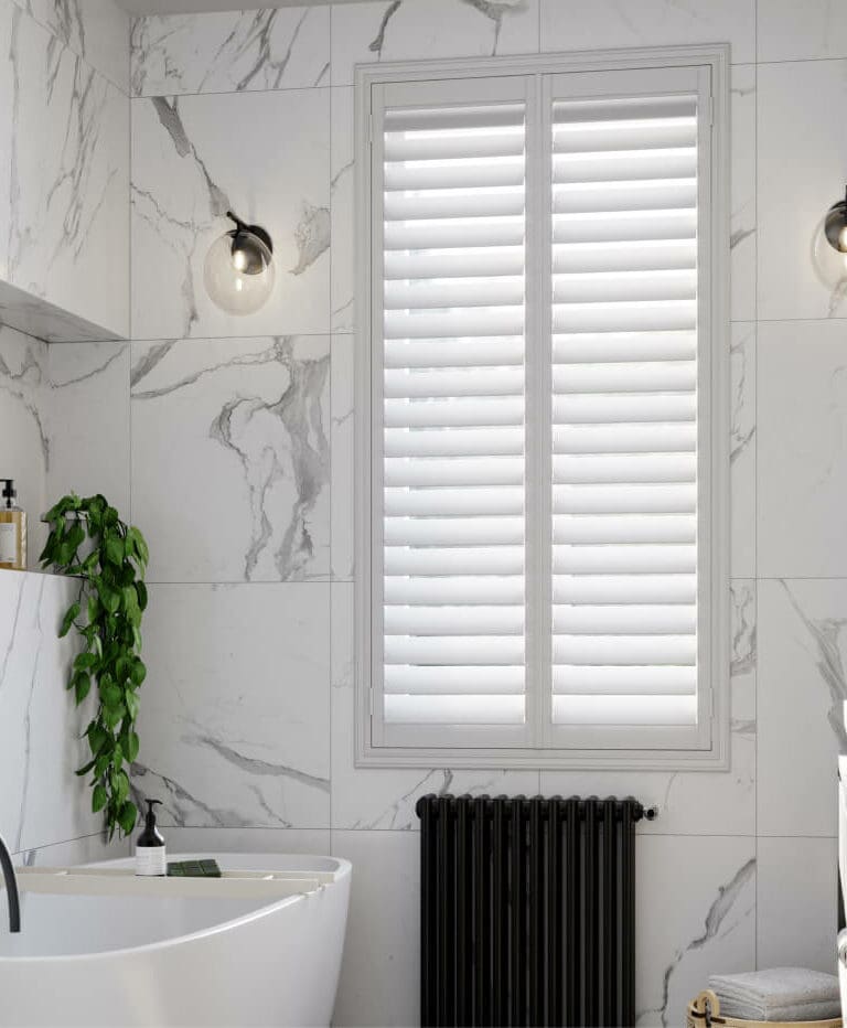White water-resistant shutters fitted in a bathroom