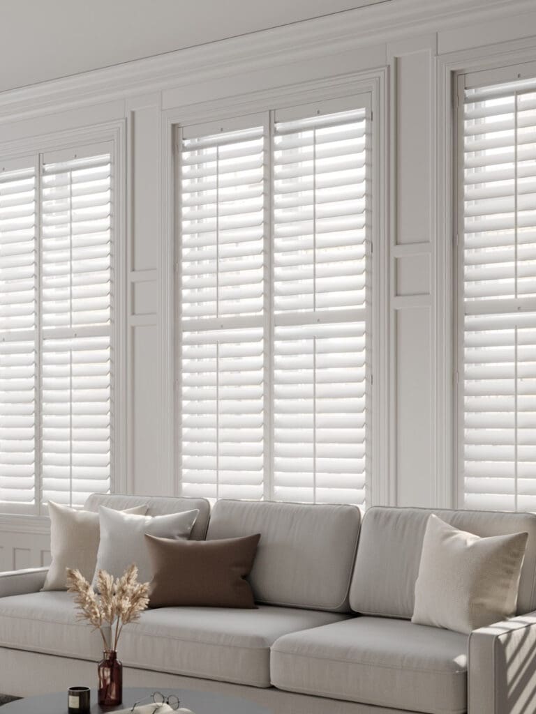 White full-height shutters in a bright living room