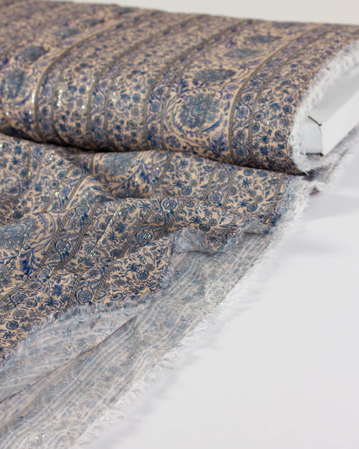 Bolt of beautiful viscose rayon fabric perfect for summer dressmaking, with a folk style print in blue and beige.