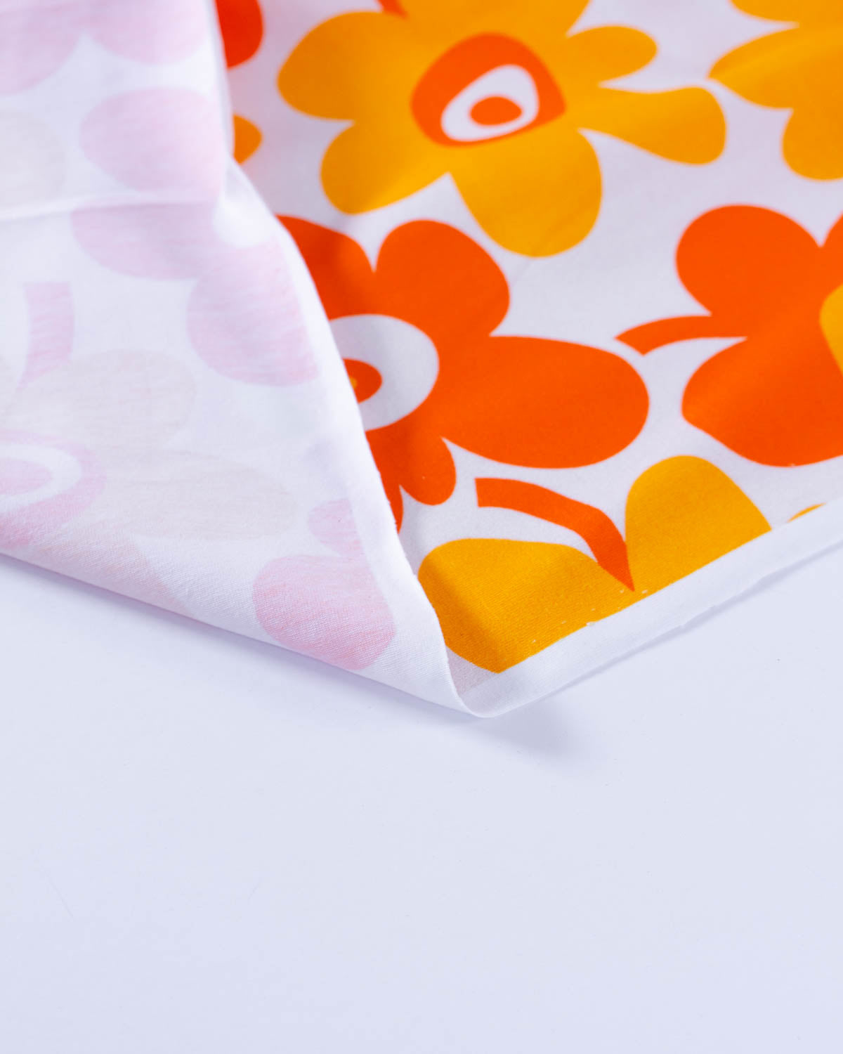 Close up image of a brightly coloured floral cotton jersey knit fabric.