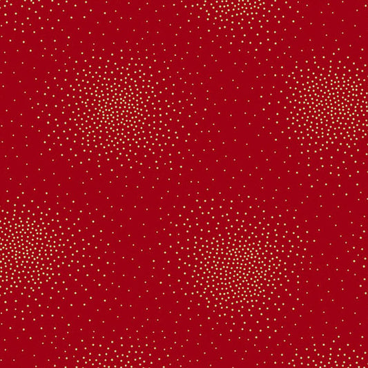 A close-up of a red cotton fabric with a repeating pattern of small metallic gold dots arranged in loose circular clusters.