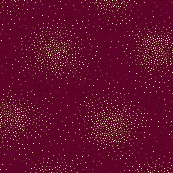 A close-up of a burgundy cotton featuring small, scattered gold metallic dots arranged in circular clusters.