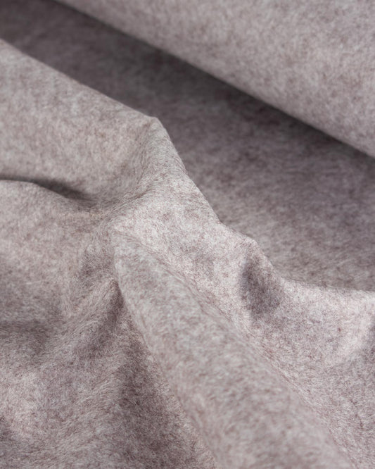 A close-up of draped wool and viscose felt fabric in a heathered taupe-gray color, showing its soft, textured surface and fine fibrous structure.