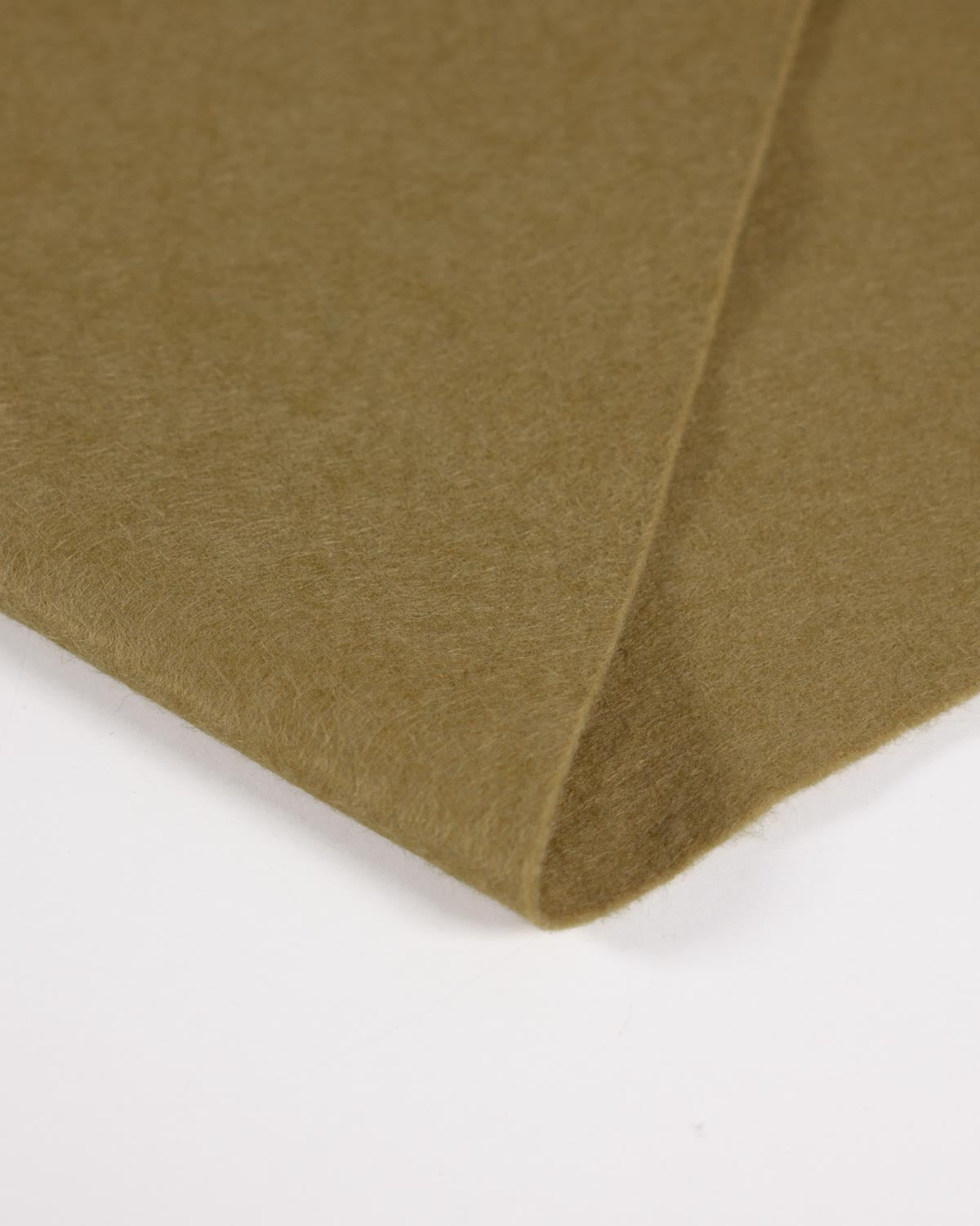 A close-up of a folded mustard olive yellow-green felt fabric showing its soft texture against a plain white background.