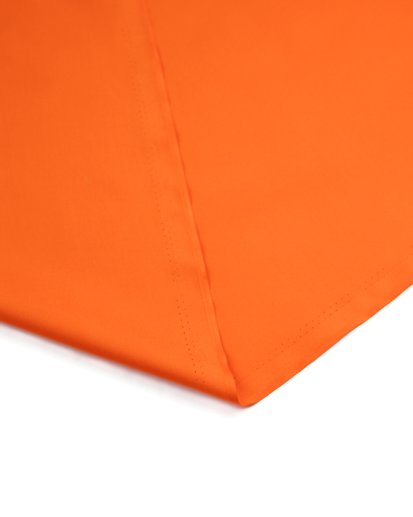Close-up of an orange fabric corner on a white background