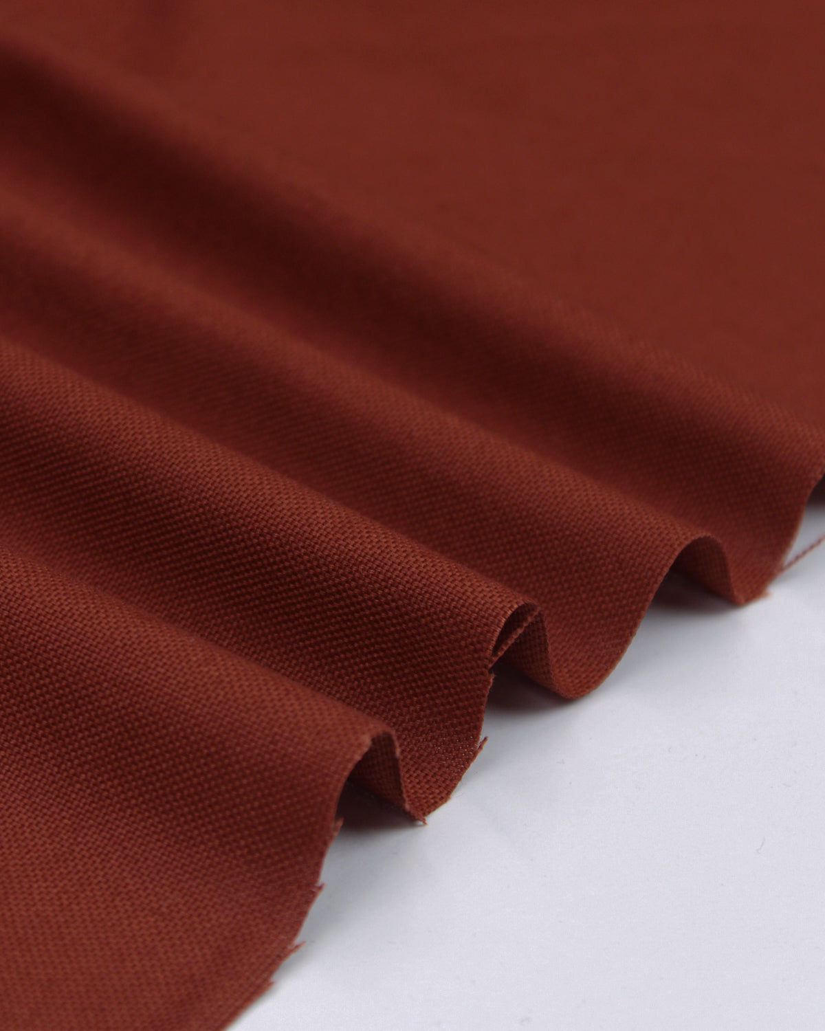Ripple view of dark chocolate pure cotton canvas fabric showing textured Panama weave