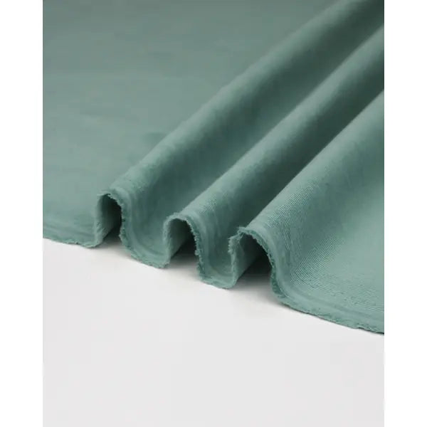 Ripple view of rockpool pale teal pure cotton babycord fabric with fine wale texture