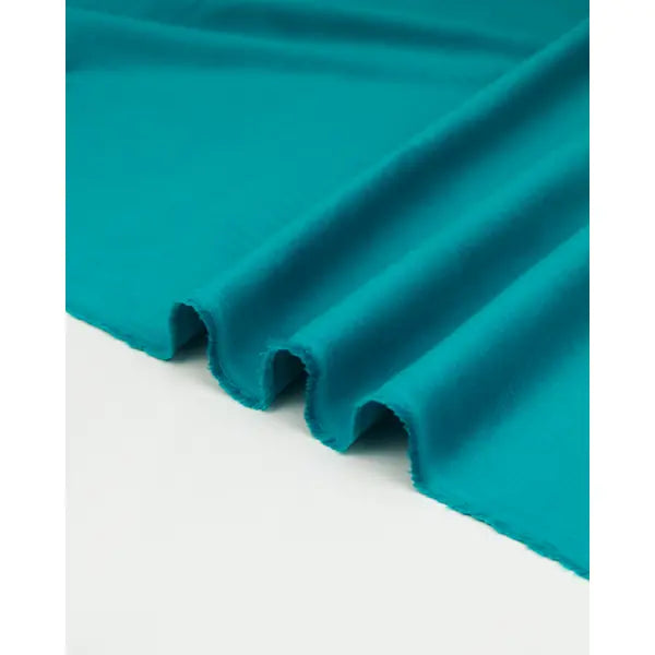 Rippled view of turquoise pure cotton babycord fabric with soft ribbed surface