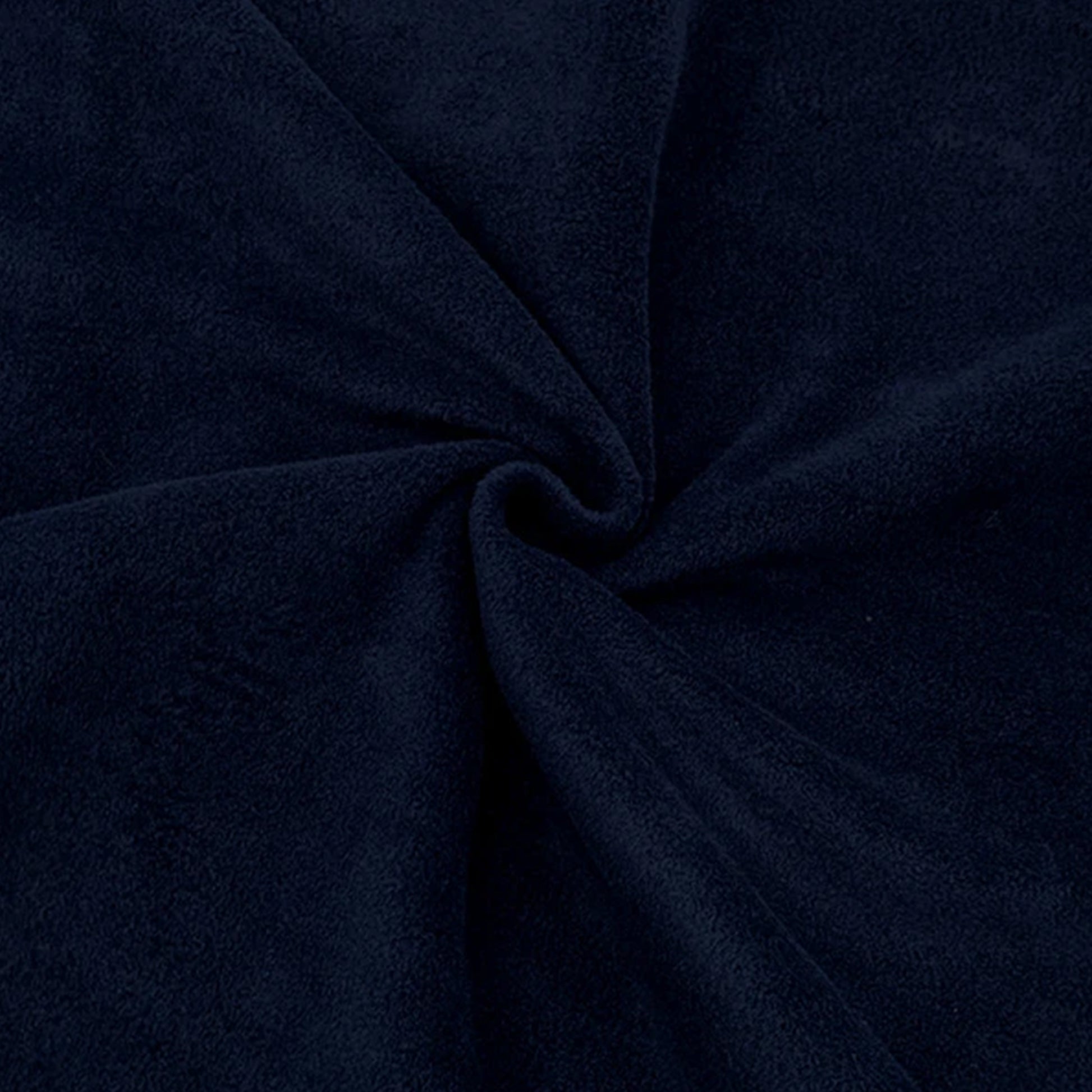 Close up of dark navy blue anti-pil polar fleece fabric showing soft plush texture