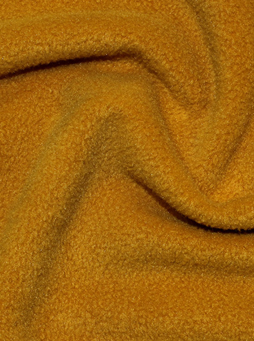 Close up of ochre anti-pil polar fleece fabric with brushed cosy surface