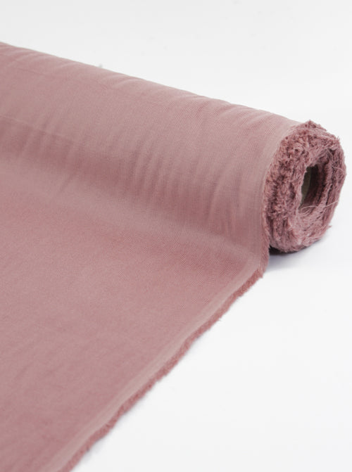 Roll of tea rose pink pure cotton babycord fabric showing delicate corduroy ridges