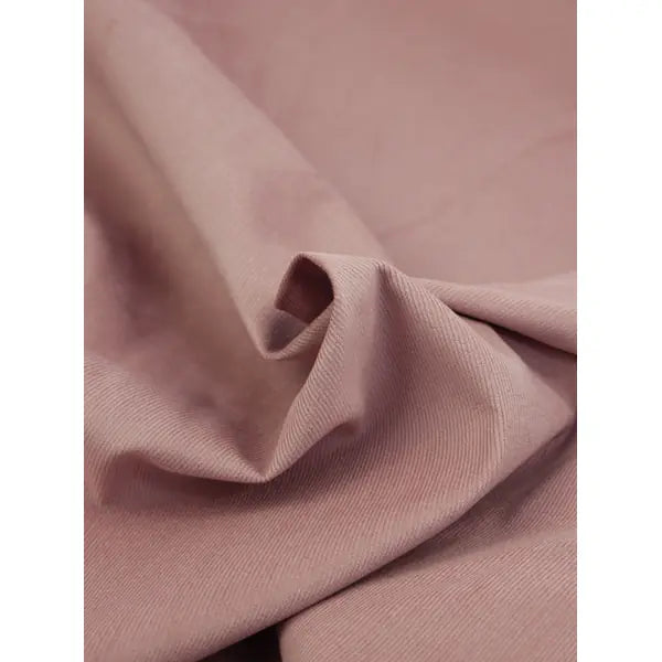 Close up of tea rose pink pure cotton babycord fabric showing delicate corduroy ridges