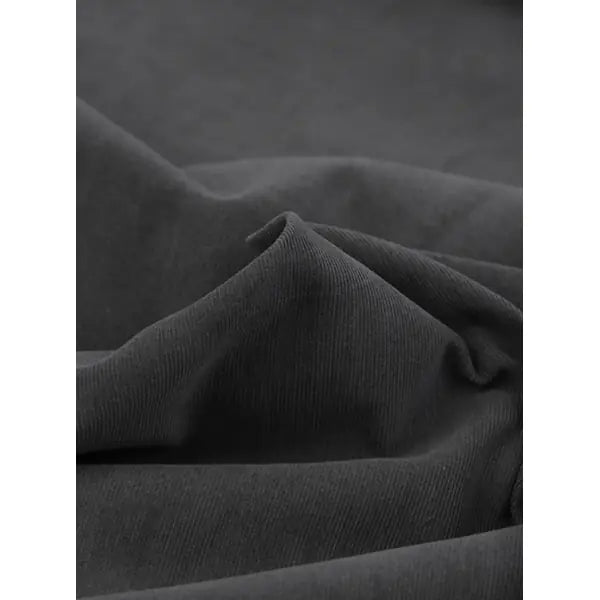 Close up of dark pebble grey pure cotton babycord fabric showing fine wale cord texture
