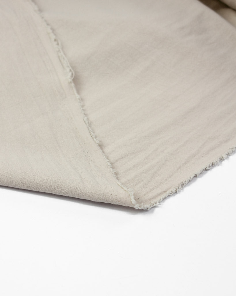 Folded over crinkle washed cotton fabric in off white