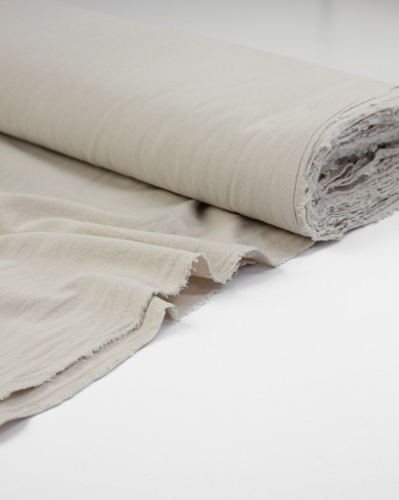 Roll of crinkle washed cotton fabric in off white