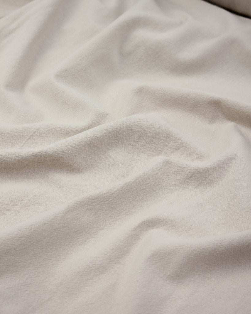 Crinkle washed cotton fabric in off white