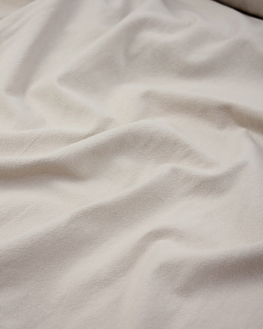 Crinkle washed cotton fabric in off white