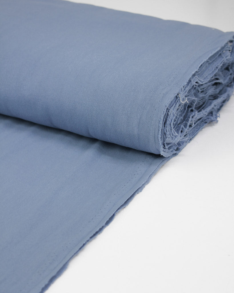 Bolt of crushed washed cotton fabric in periwinkle blue