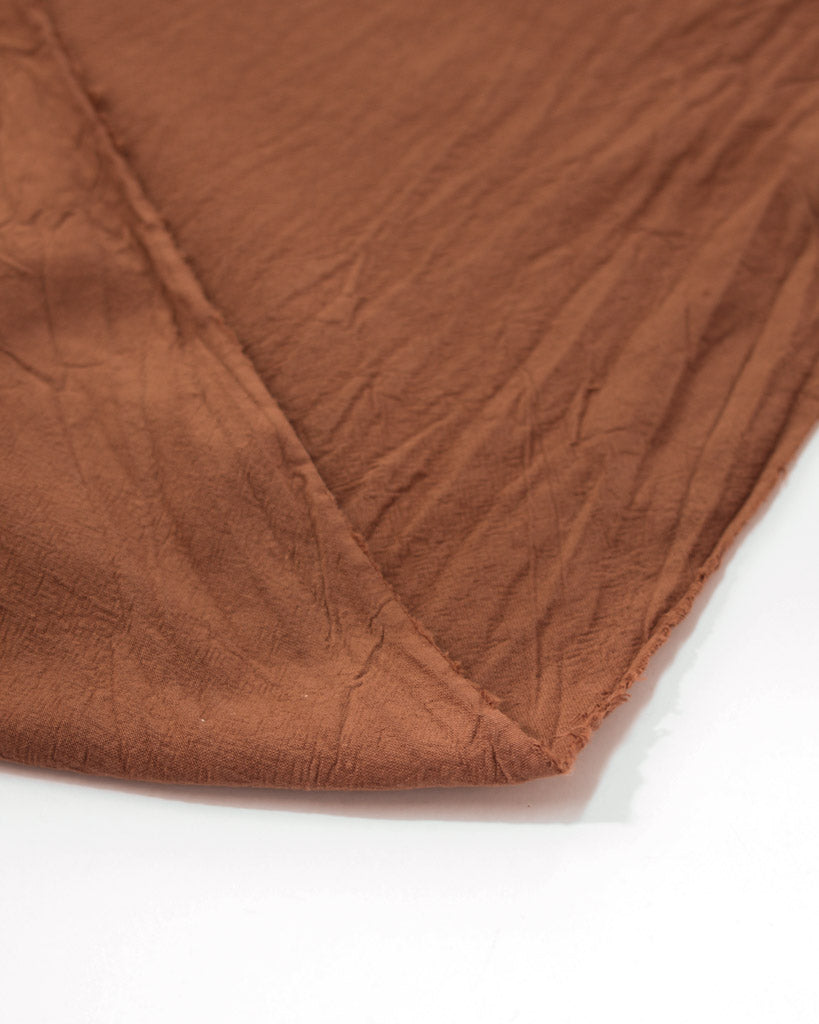Washed crushed cotton fabric in cinnamon brown