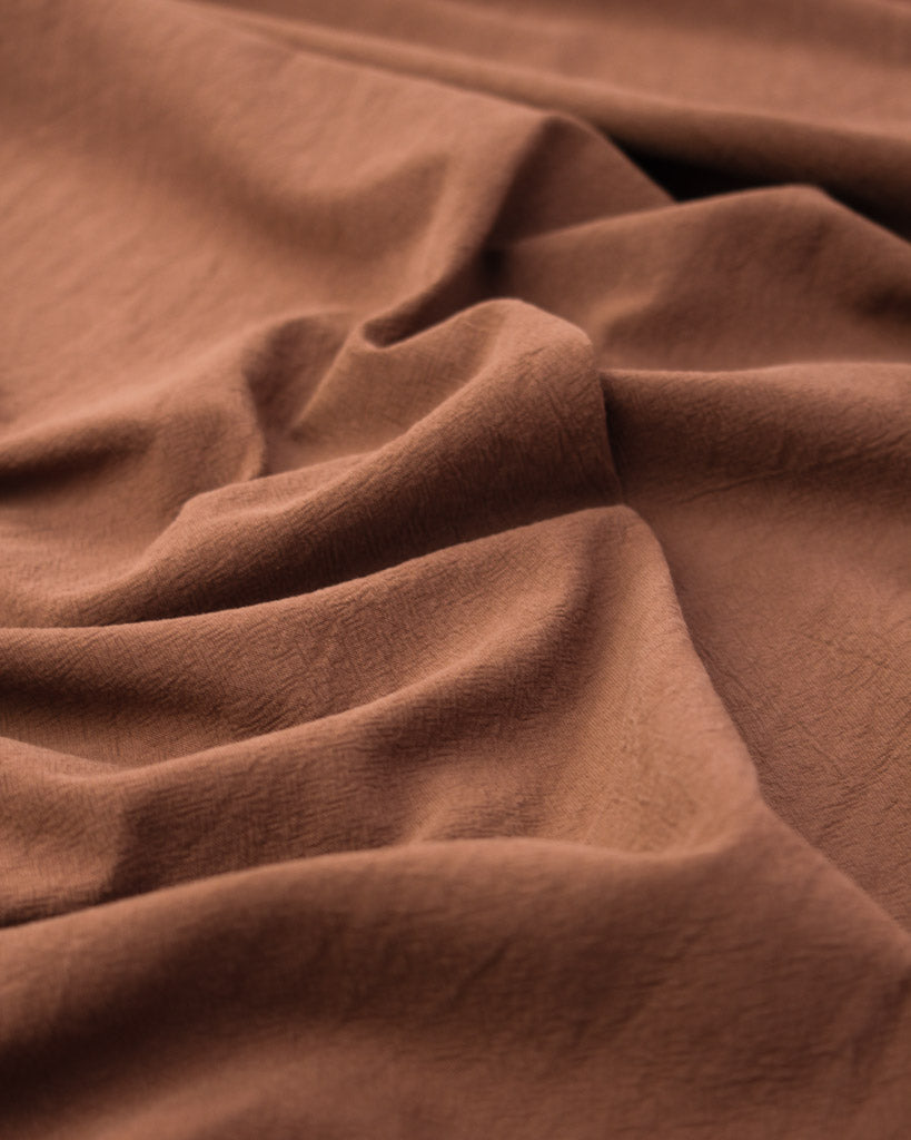 Washed crushed cotton fabric in cinnamon brown