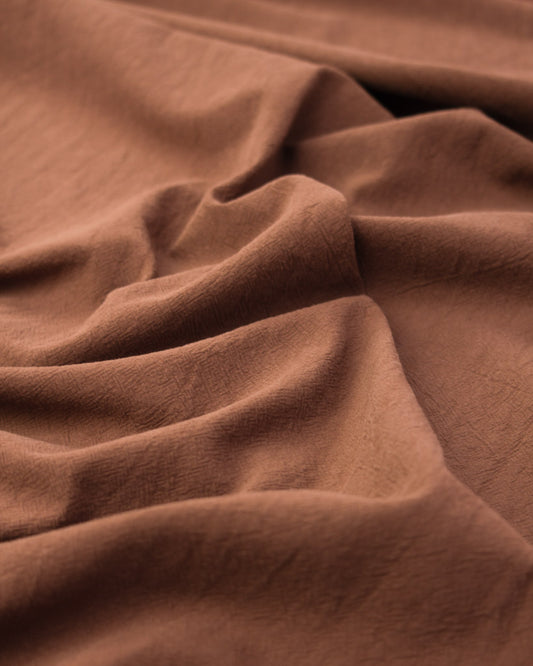 Washed crushed cotton fabric in cinnamon brown