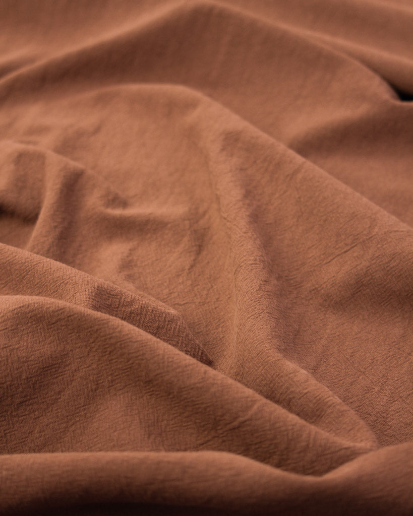 Washed crushed cotton fabric in cinnamon brown