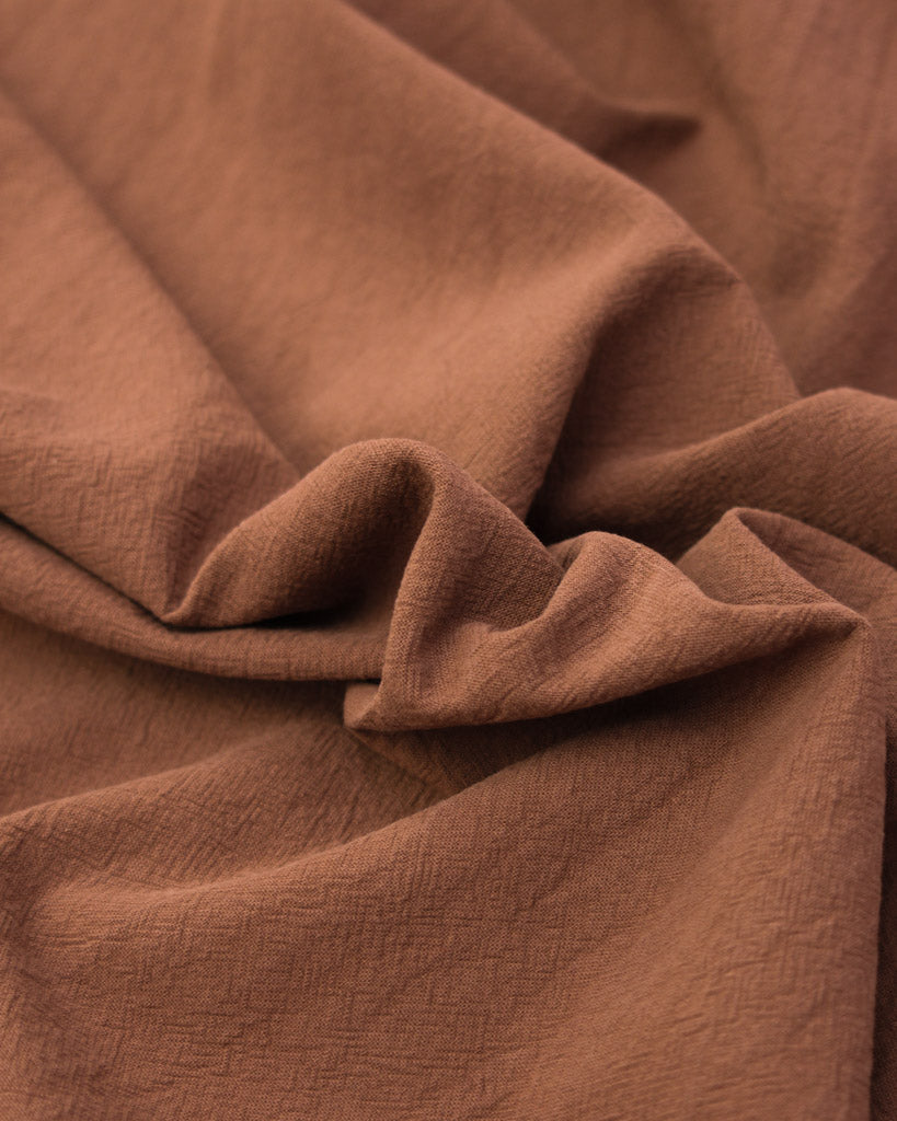 Close up of washed crushed cotton fabric in cinnamon brown