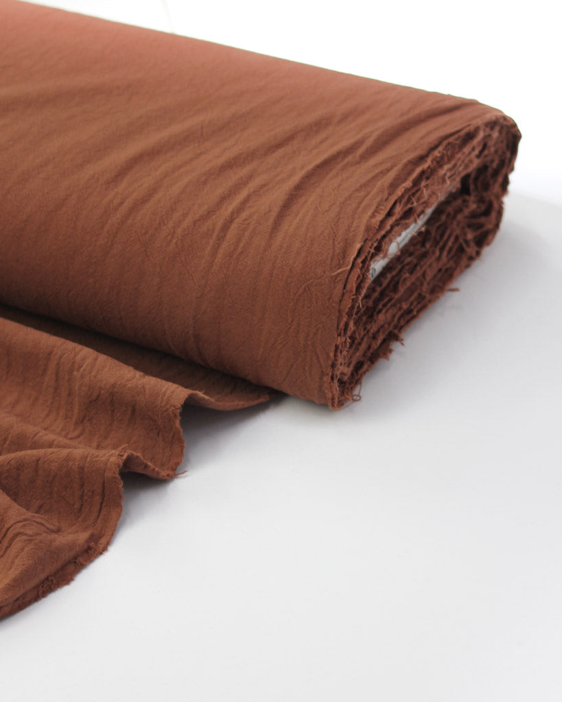 Bolt of washed crushed cotton fabric in cinnamon brown