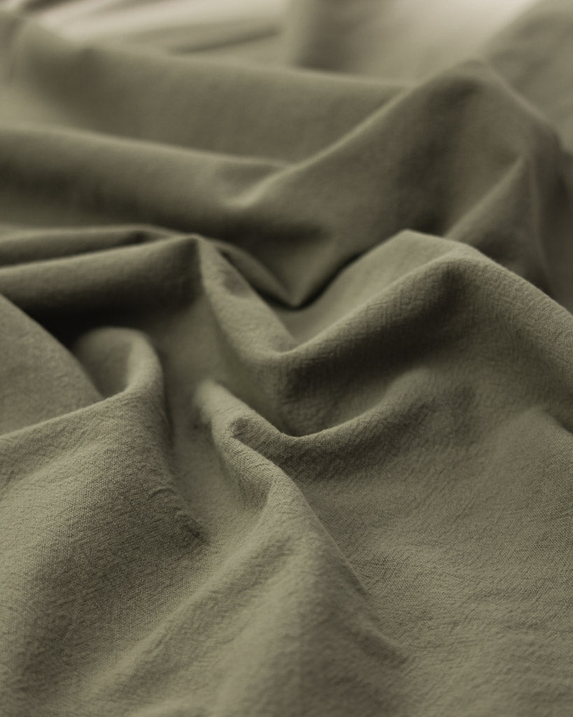 crushed washed cotton fabric in a soft grey-green