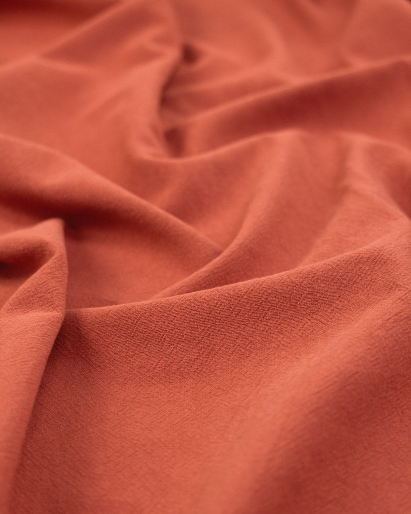 crushed washed cotton fabric in hot red-orange
